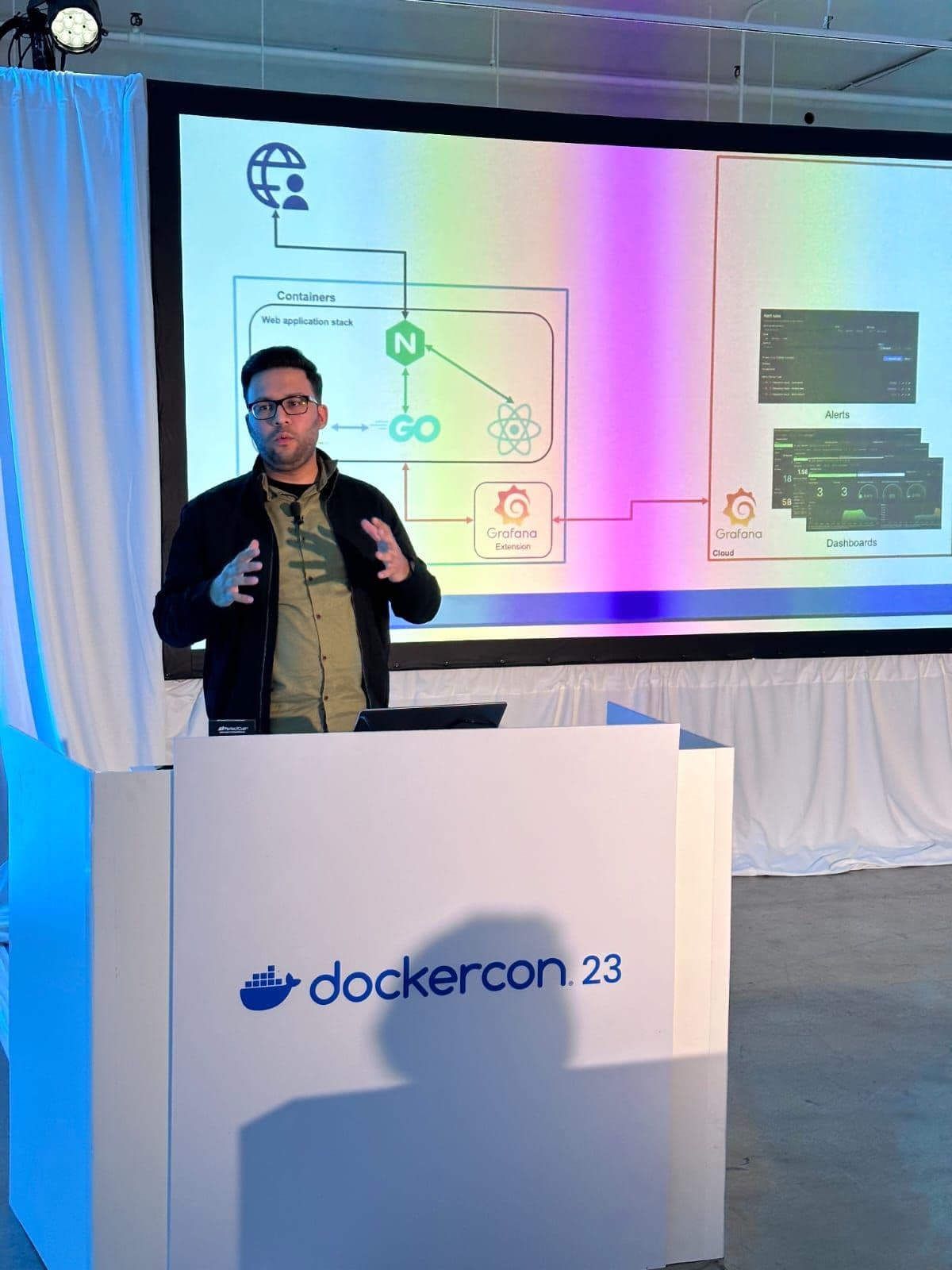 Muhammad Shahzeb presenting on stage at DockerCon 2023 in Los Angeles